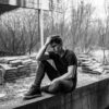 Man Sitting On Concrete Bench