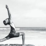 man stretching on seashore