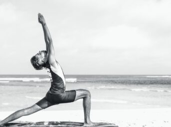 man stretching on seashore