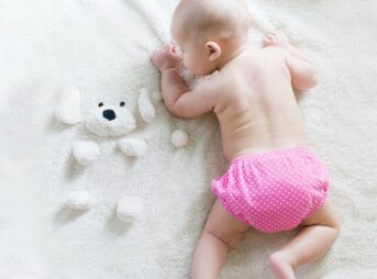 baby crawling on bed