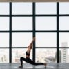 woman in black tank top and black leggings doing yoga